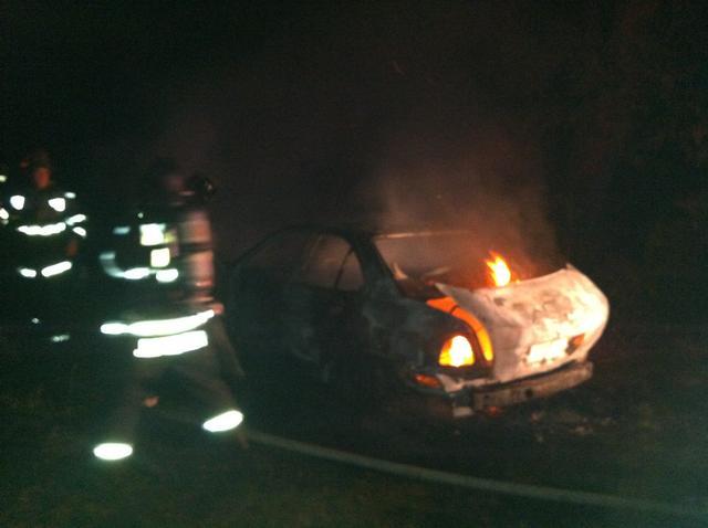 Firefighters douse a car fire off Chaptico Road in Helen